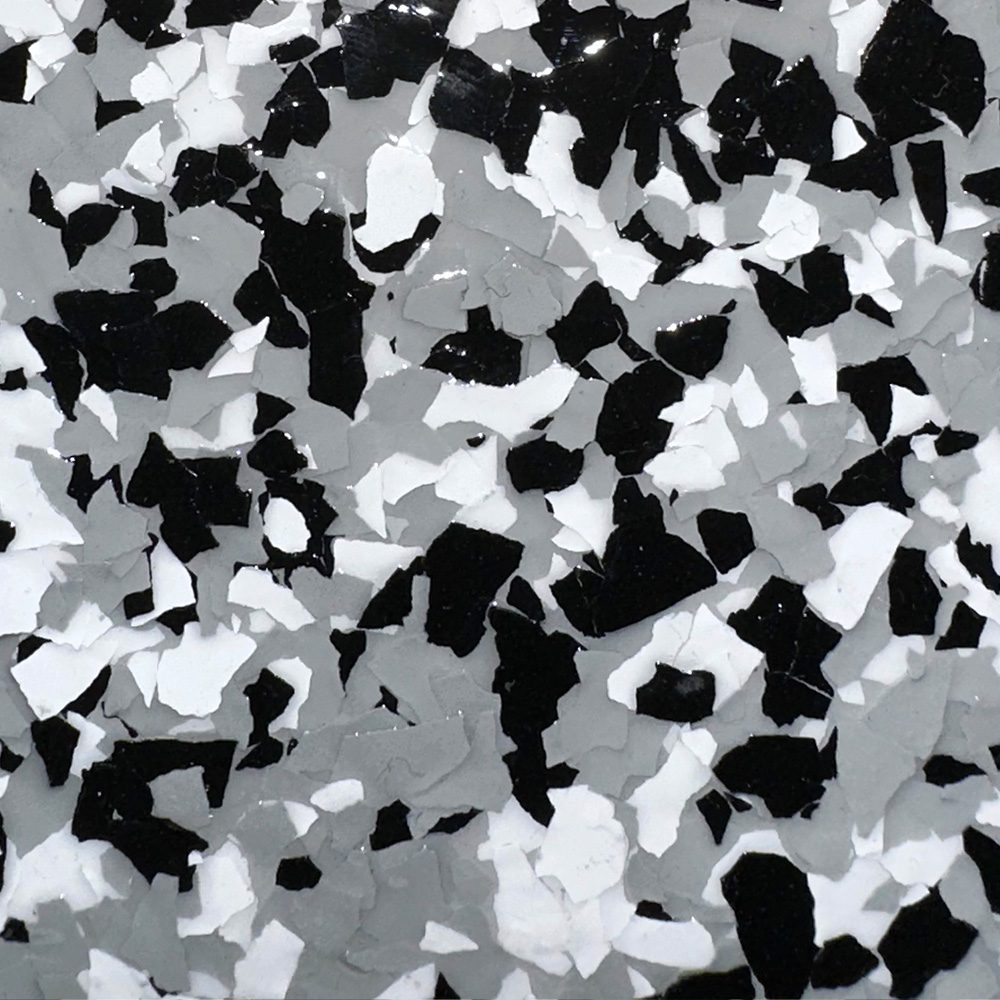 Tuxedo Flake garage floor finish featuring a blend of black, white, and gray flakes, showcasing natural texture and elevated style from the Stone Series.